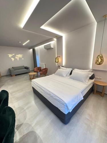 a bedroom with a large bed and a living room at Meteora Gold and Glass in Kalabaka