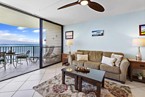 a living room with a couch and a table at Kahana Reef 318 in Kahana