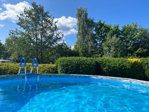 a large blue swimming pool with two m signs on it at Hotýlek u Kance in Lipova Lazne