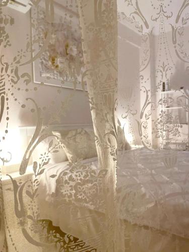 a bedroom with a white bed with a canopy at White House Kavala in Kavála