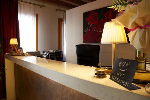 an office with a reception desk with a lamp at UNAHOTELS Eco Hotel Villa Costanza Venezia in Mestre