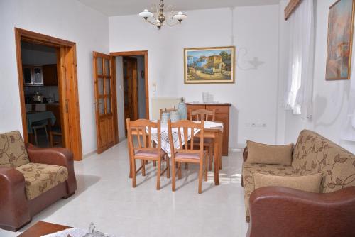 a kitchen and dining room with a table and chairs at ZeusPlace Konaki House Leptokarya in Leptokaria