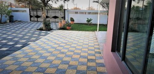 a patio with a blue and yellow tile floor at Country Block-Holiday home in Kgaphamadi