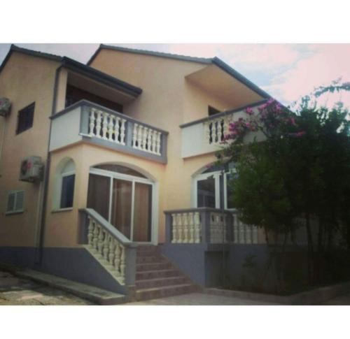 a large house with stairs in front of it at Studio 2+2 in Pakoštane