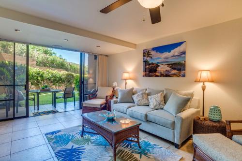 a living room with a couch and a table at Kahana Villa E111 in Kahana