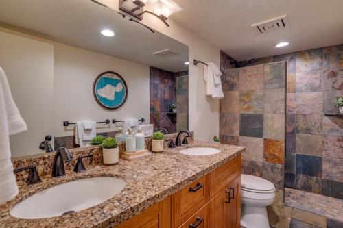 a bathroom with two sinks and a shower at Kahana Villa E111 in Kahana