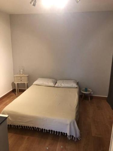 une chambre avec un lit blanc et une table dans l'établissement Appartement rénové RDC terrasse 200m plage, à Port-la-Nouvelle