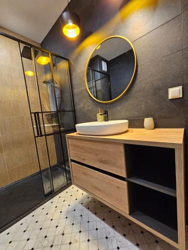 a bathroom with a sink and a mirror at Pachnące Sny Apartament in Elblag