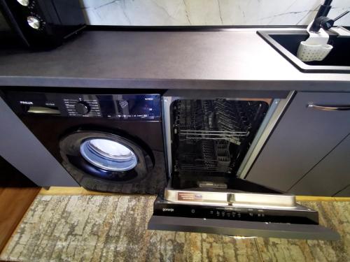 a microwave sitting under a counter in a kitchen at Viva 3 Grand monastery in Pamporovo