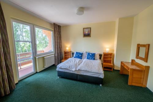 a hotel room with a bed and a window at Rekreačné zariadenie Oliva - Patince in Patince