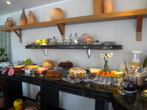 a table with a bunch of food on it at Novo Hamburgo Business Hotel in Novo Hamburgo