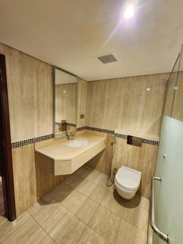 a bathroom with a sink and a toilet at Helnan Royal in Dubai