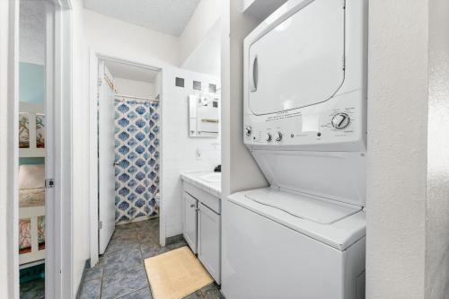 a white bathroom with a sink and a mirror at Kihei Akahi B102 in Wailea