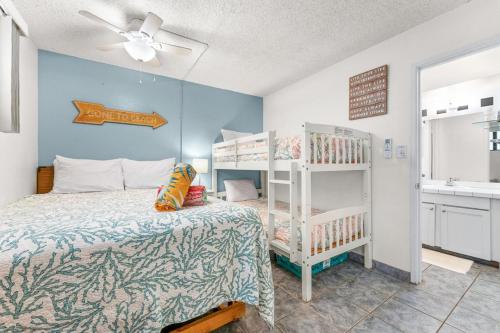 a bedroom with a bed and a bunk bed at Kihei Akahi B102 in Wailea