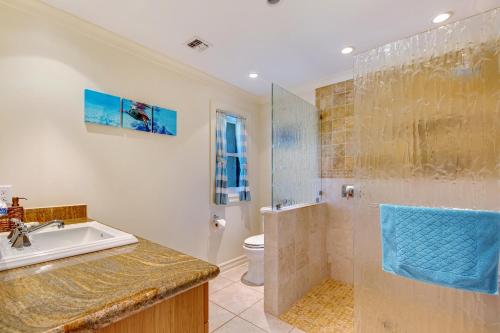 a bathroom with a shower and a sink and a toilet at Kapalua Golf Villa 27V 3 in Kahana