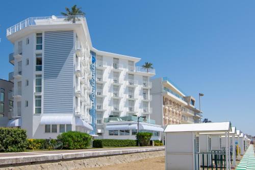 un hotel en la playa junto a un edificio en Hotel Montecarlo, en Caorle