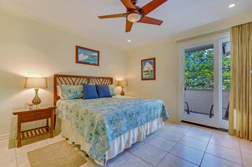 a bedroom with a bed and a ceiling fan at Kapalua Golf Villa 27V 3 in Kahana