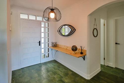 a hallway with a white door and a mirror at Villa Mar in Alcossebre