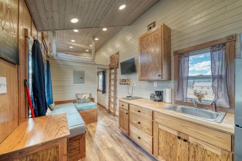 a kitchen with wooden cabinets and a sink and a window at Tiny House Leadville Colorado in Leadville