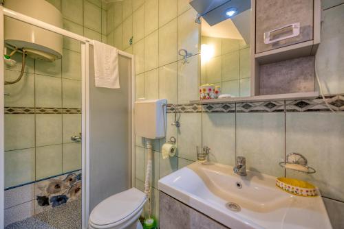 a small bathroom with a toilet and a sink at Apartments Vujosevic in Tivat