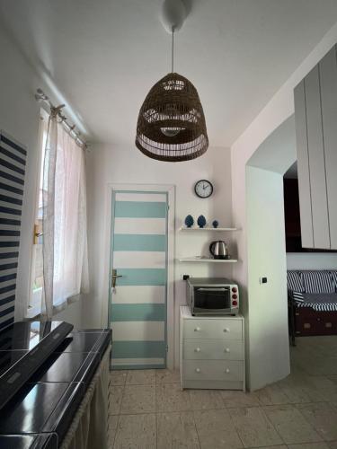a kitchen with a blue door and a microwave at Seahouse Bocca di Magra in Bocca di Magra
