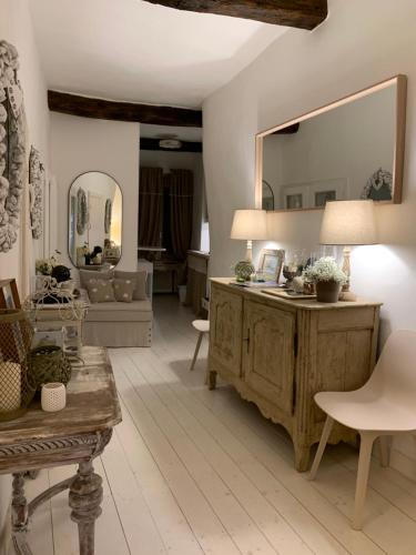 a living room with a table and a mirror at Camogli in Love La casetta sul mare in Camogli