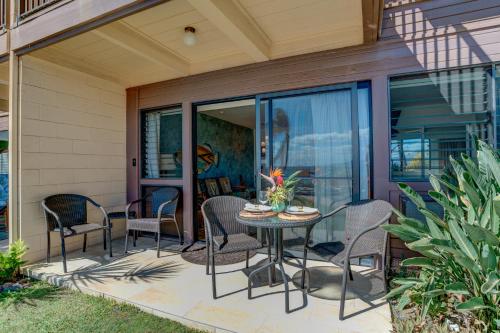 a patio with chairs and a table on a house at Hono Kai A7 in Kihei