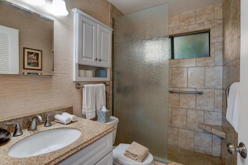 a bathroom with a toilet and a sink and a shower at Hono Kai A7 in Kihei