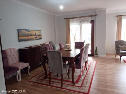 a living room with a dining room table and chairs at Mimoza Park House in Trabzon