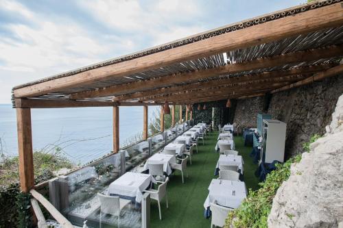a row of white tables and chairs on a building at Hotel Villa Pandora in Maiori