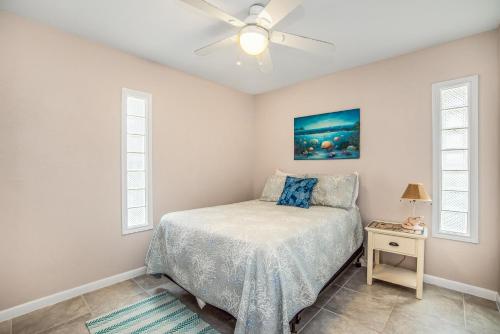 a bedroom with a bed and a ceiling fan at Blue Horizon HUGE Private Pool and yard with Outside shower! in Port Aransas