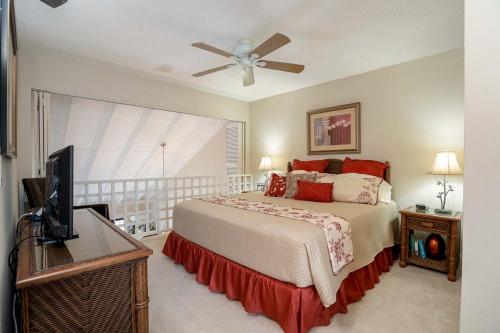 a bedroom with a bed and a flat screen tv at Maui Kamaole G208 in Wailea