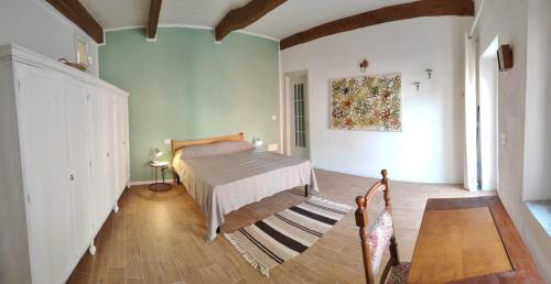 a bedroom with a bed in the middle of a room at Magalocanda stanze sotto al castello in Montemagno
