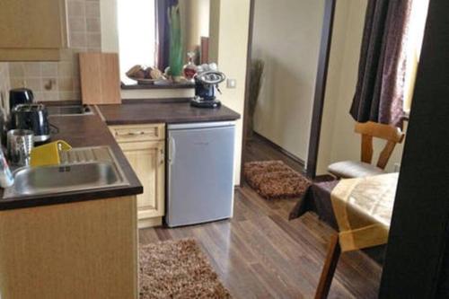 a kitchen with a sink and a dishwasher at Cosy Apartment near Faaker See in Latschach