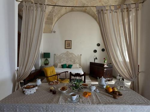 a room with a bed with a table with food on it at B&b l'Orangerie D'epoque in Lecce