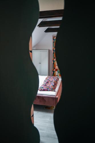 a view of a bedroom with a bed in it at Dunakavics XIII Apartman in Szentendre