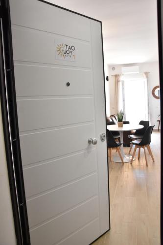 a white closet door in a room with a table at Tao enJoy Suite in Taormina