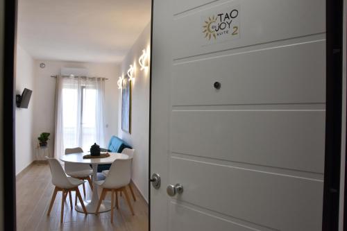 a door leading into a room with a table and chairs at Tao enJoy Suite in Taormina