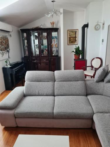 a living room with a couch and a piano at Delux apartman Sue in Split