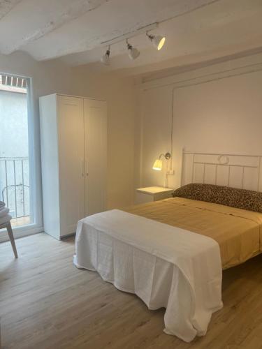 a bedroom with a large bed and a large window at Añisclo in Barbastro