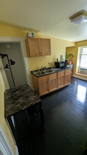 a kitchen with a sink and a counter top at Historic Row House in Elmira