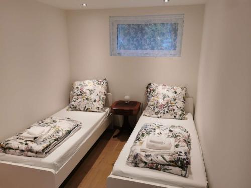 ein kleines Zimmer mit 2 Betten und einem Fenster in der Unterkunft FeWo Interlaken in Interlaken