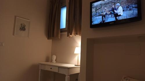 a television hanging on a wall in a room at Dimora Rosantica in Ariano Irpino