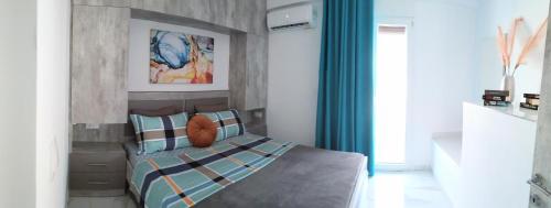 a bedroom with a bed with a blue curtain at Luxurious Maisonettes Nina & Tomas in Sivota in Sivota