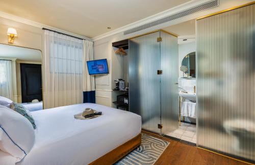 a hotel room with a bed and a television at Villa Brown Tel-Aviv, a member of Brown Hotels in Tel Aviv