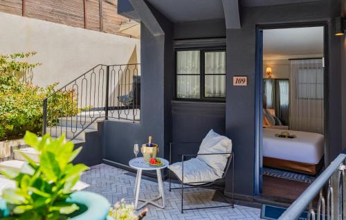 a room with a balcony with a bed and a table at Villa Brown Tel-Aviv, a member of Brown Hotels in Tel Aviv