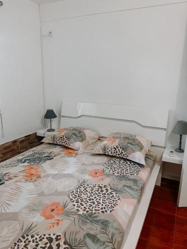 a bedroom with a bed with flowers on it at Résidence Le Palmier Royal in Sainte-Rose