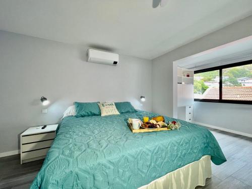 a bedroom with a bed with a tray of fruit on it at Ocean Front in Paul do Mar