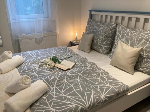 a bed with a tray of books and flowers on it at Carina Apartment in Budapest