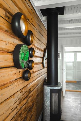 a room with a wooden wall with a wood stove at Lofoten Villa in Reine